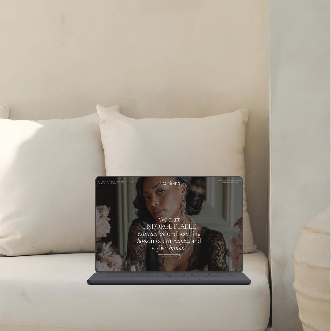 Laptop with a fashion website open, placed on a white bed with pillows in a minimalist room.