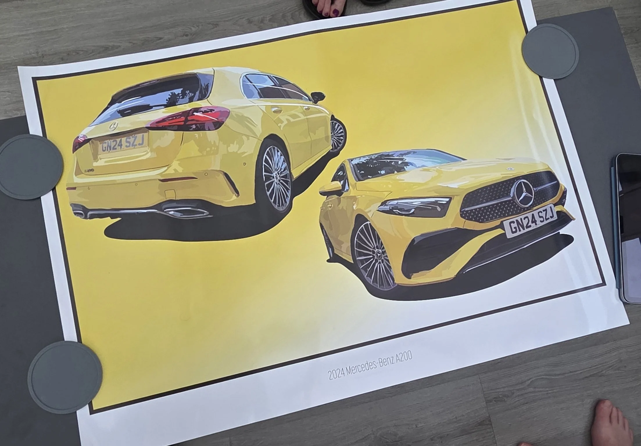 Image of a yellow 2024 Mercedes-Benz A200 car, showing the rear and front view, placed on a bright yellow background.