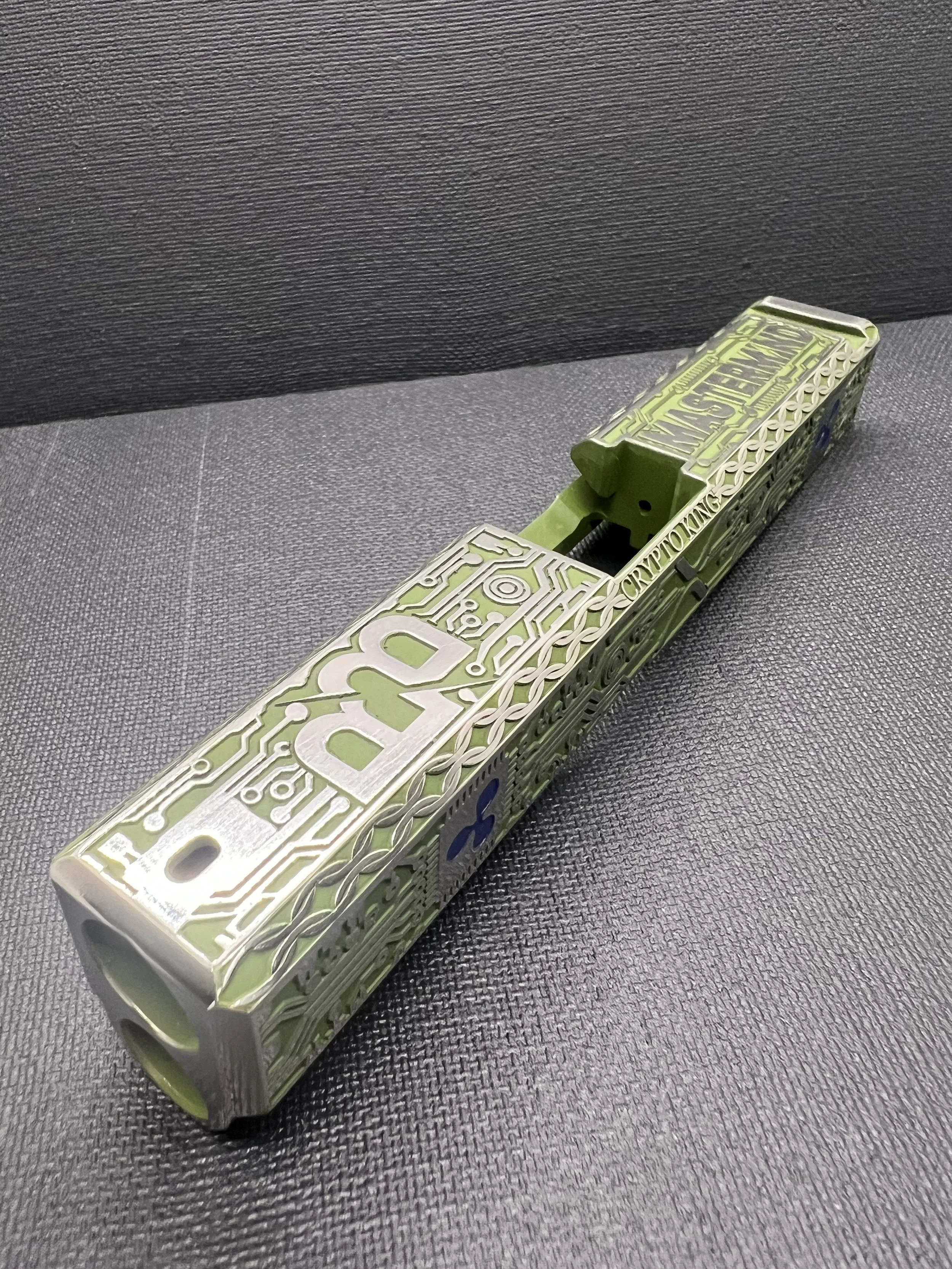 Custom Glock® 17 Gen 5, Ripple XRP themed, slide with circuit-style engraving and green Cerakote finish, designed, laser engraved, and custom finished for a client project.