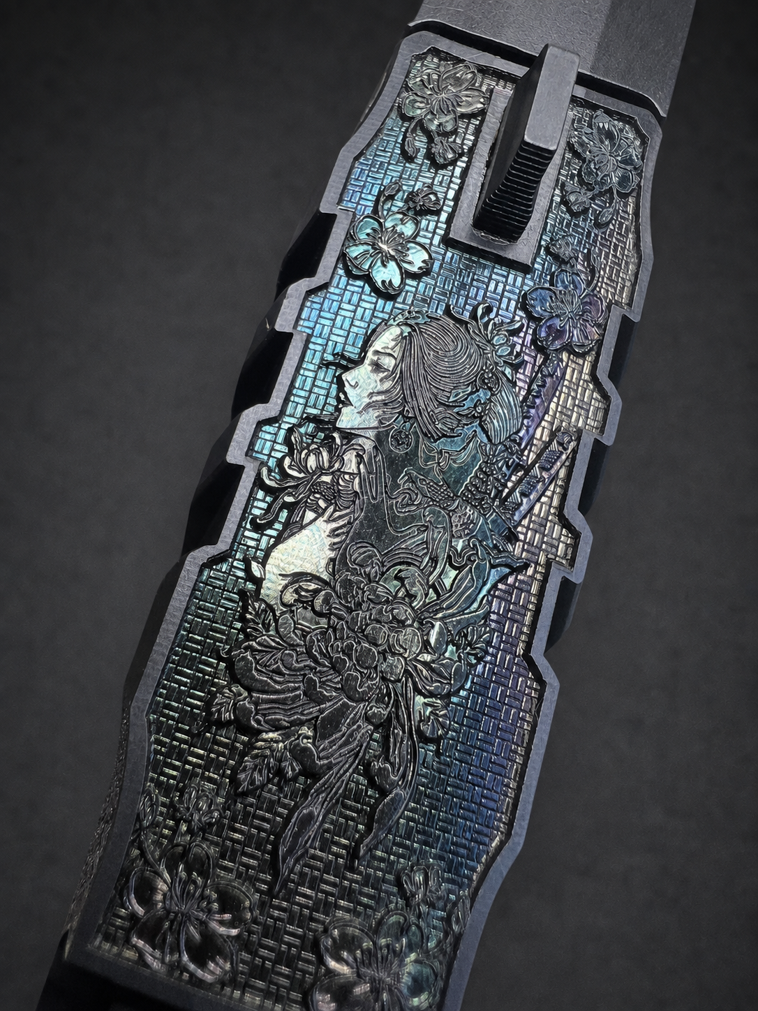 Oblique top view of Walther PDP Pro slide with floral figure engraving, iridescent laser-polish accents and etched linework