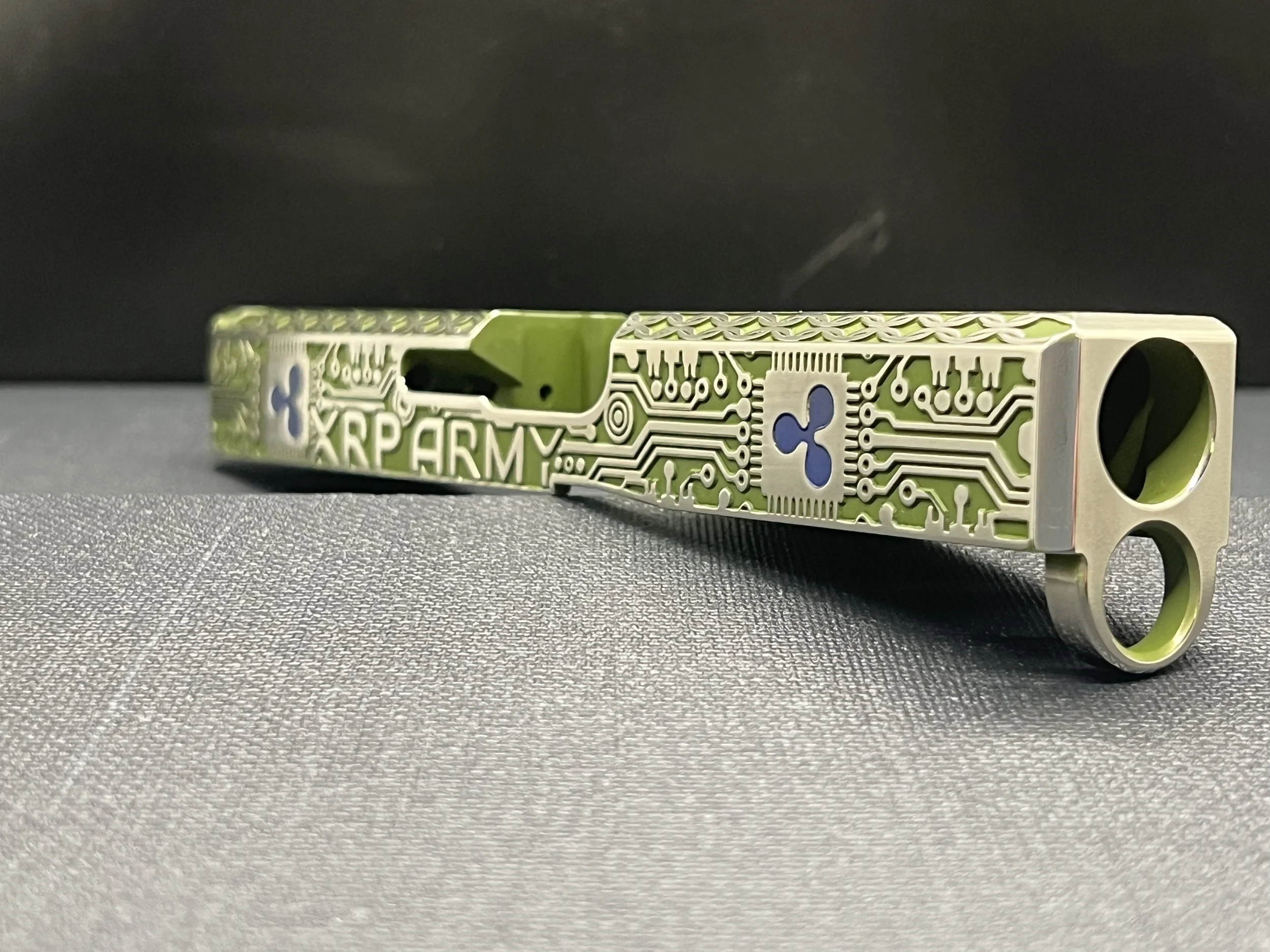 Custom Glock® 17 Gen 5, Ripple XRP themed, slide with circuit-style engraving and green Cerakote finish, designed, laser engraved, and custom finished for a client project.