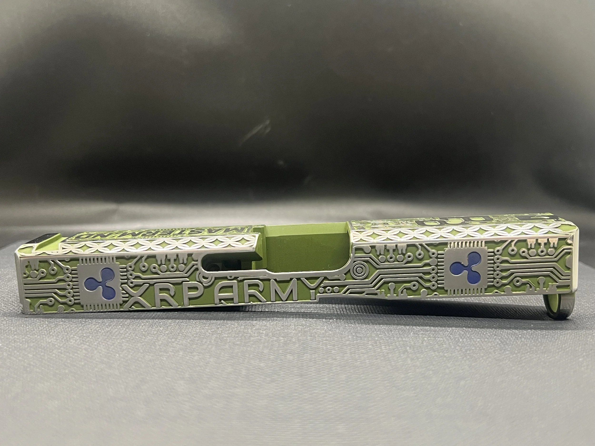 Custom Glock® 17 Gen 5, Ripple XRP themed, slide with circuit-style engraving and green Cerakote finish, designed, laser engraved, and custom finished for a client project.