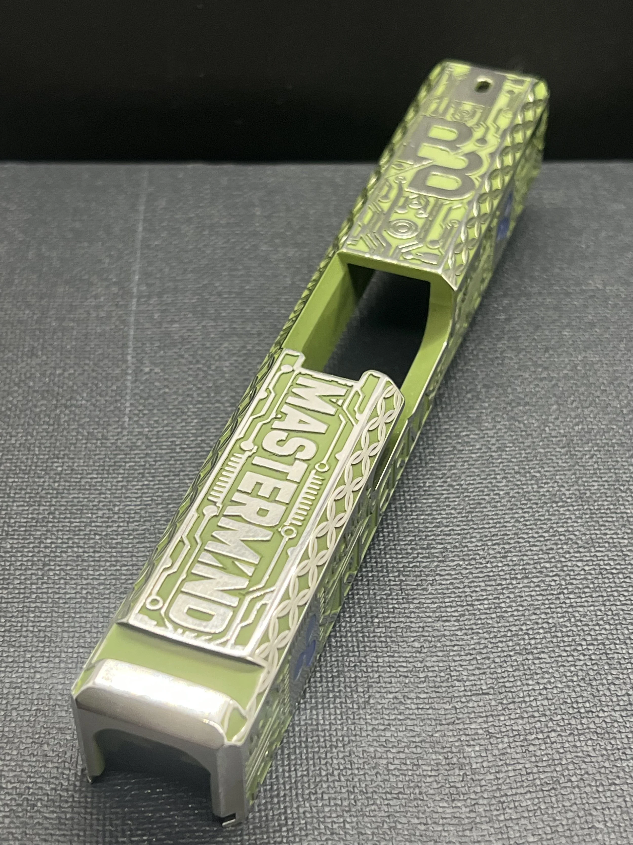 Custom Glock® 17 Gen 5, Ripple XRP themed, slide with circuit-style engraving and green Cerakote finish, designed, laser engraved, and custom finished for a client project.
