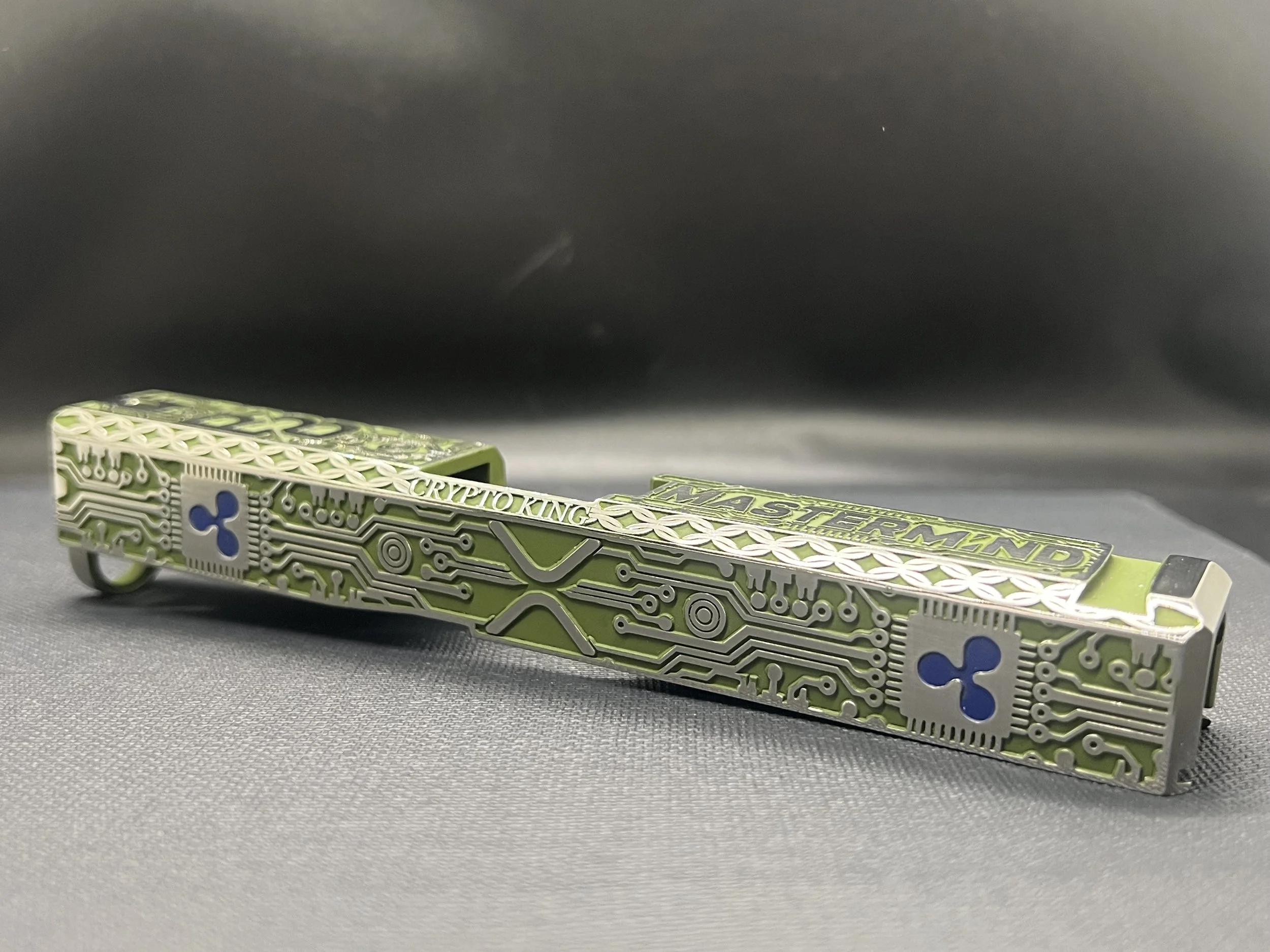 Custom Glock® 17 Gen 5, Ripple XRP themed, slide with circuit-style engraving and green Cerakote finish, designed, laser engraved, and custom finished for a client project.