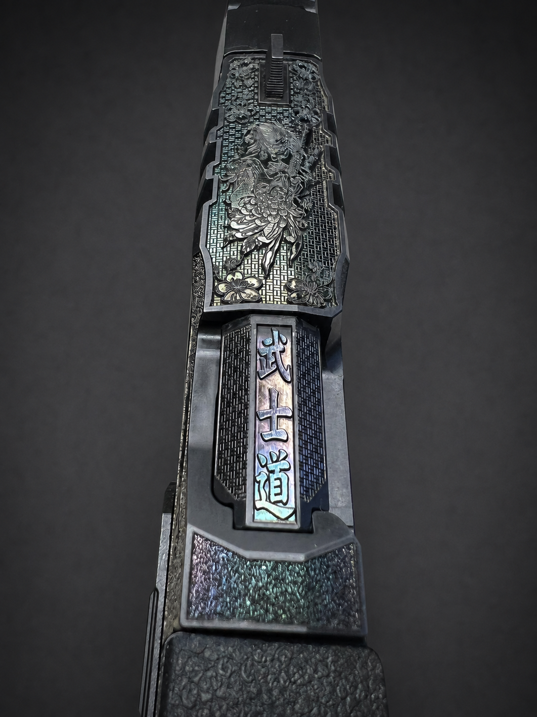 Top view of Walther PDP Pro slide with engraved Japanese-inspired woman, flowers, woven pattern and color-shifting finish