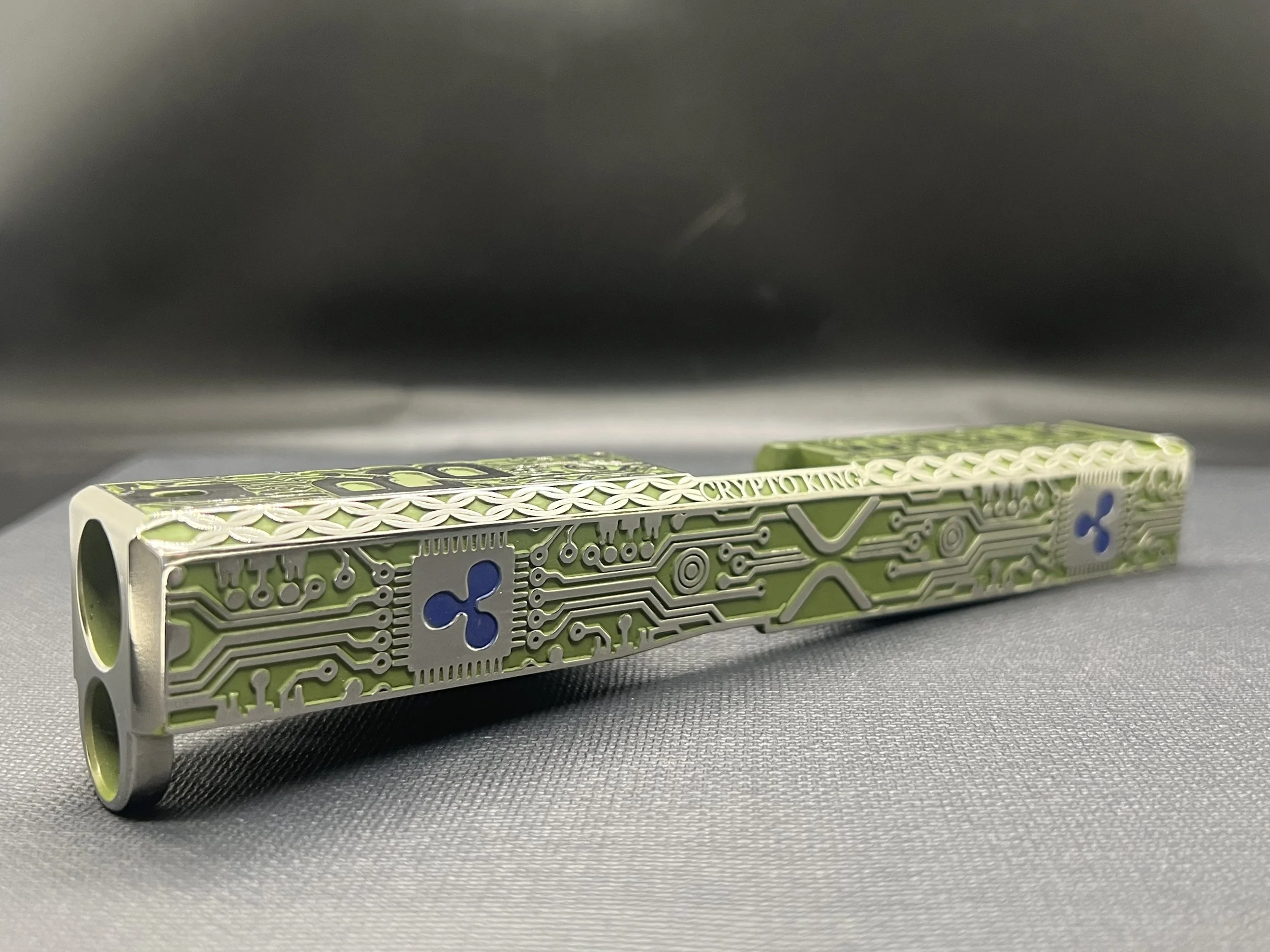 Custom Glock® 17 Gen 5, Ripple XRP themed, slide with circuit-style engraving and green Cerakote finish, designed, laser engraved, and custom finished for a client project.
