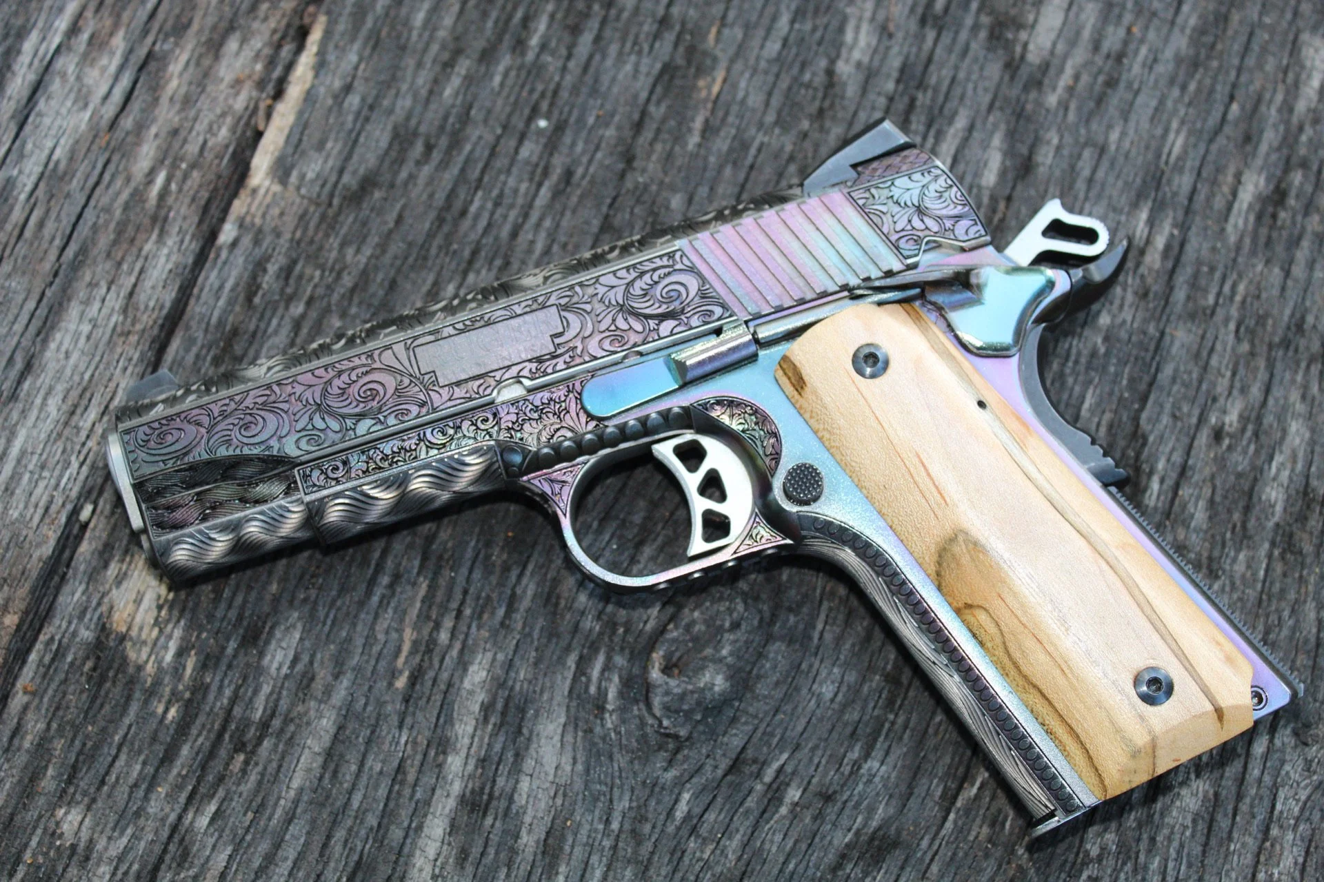 Custom engraved Ruger 1911 pistol featuring intricate scrollwork and wood grips, designed for a client