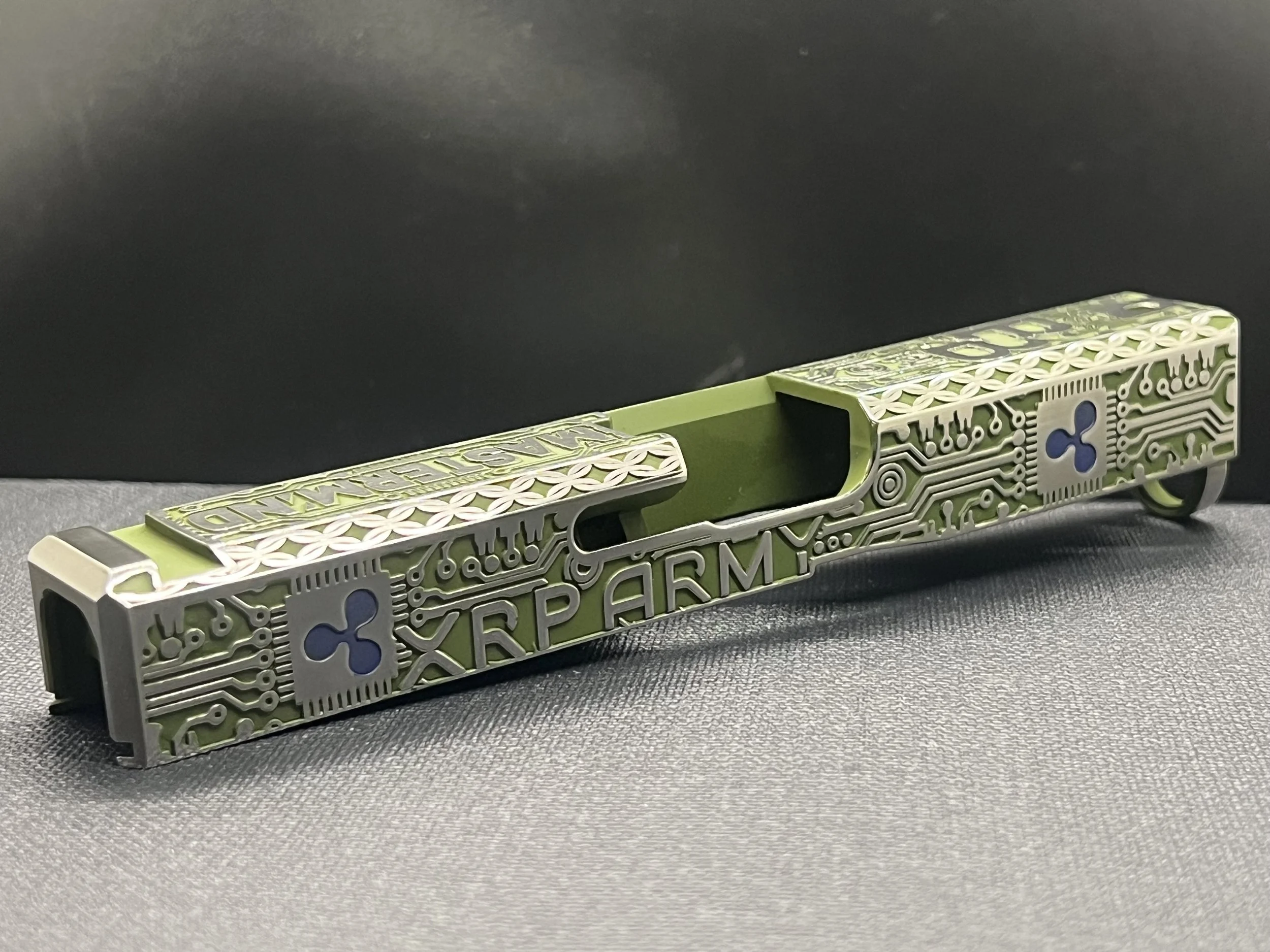 Custom Glock® 17 Gen 5, Ripple XRP themed, slide with circuit-style engraving and green Cerakote finish, designed, laser engraved, and custom finished for a client project.