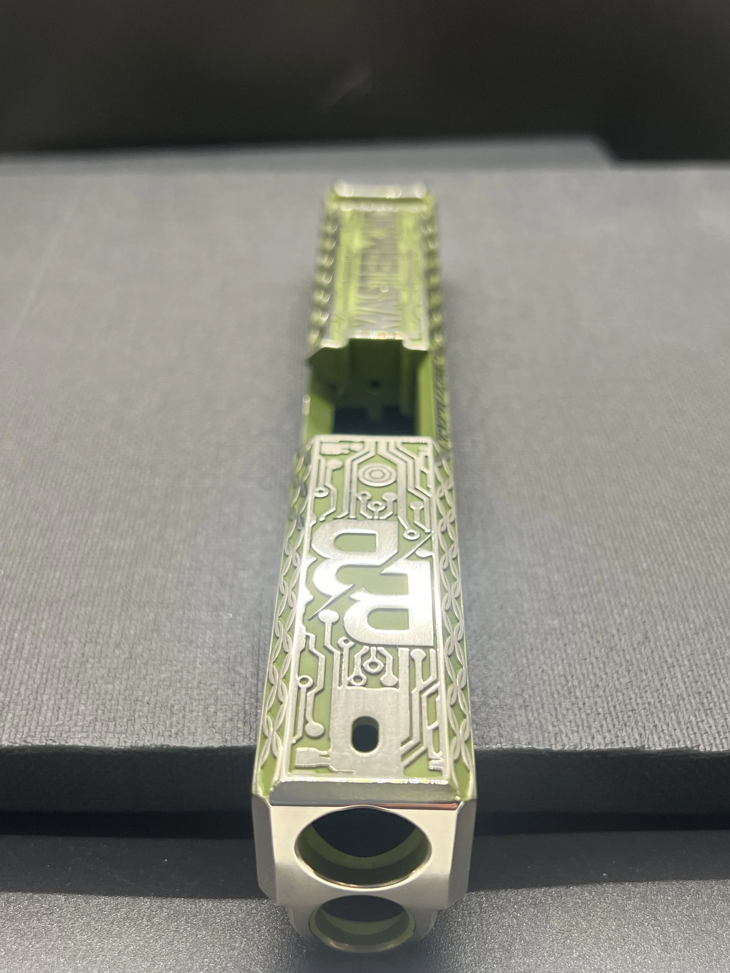 Custom Glock® 17 Gen 5, Ripple XRP themed, slide with circuit-style engraving and green Cerakote finish, designed, laser engraved, and custom finished for a client project.