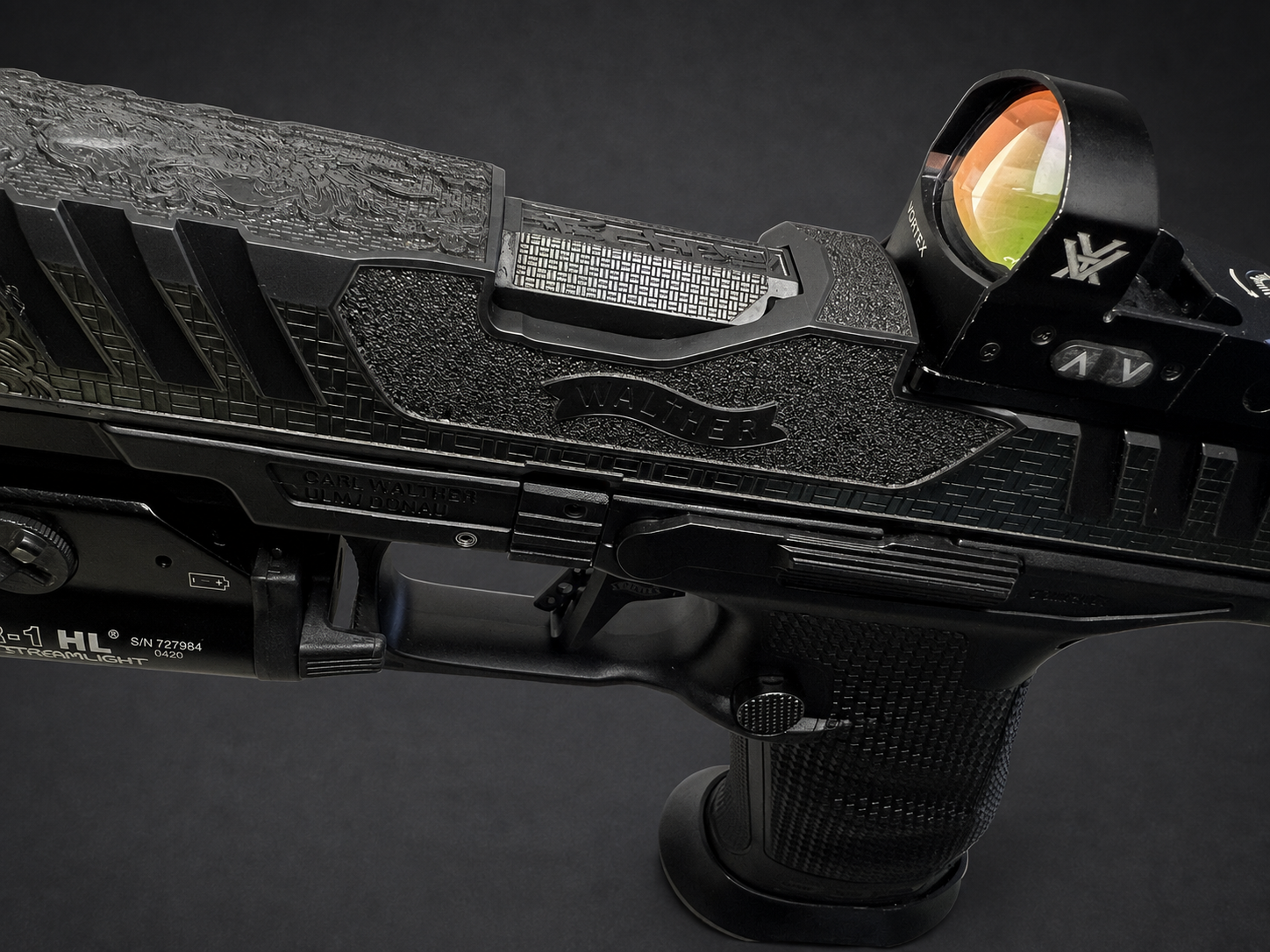 Angled view of custom Walther PDP Pro slide engraving, geometric linework and Vortex optic under studio lighting
