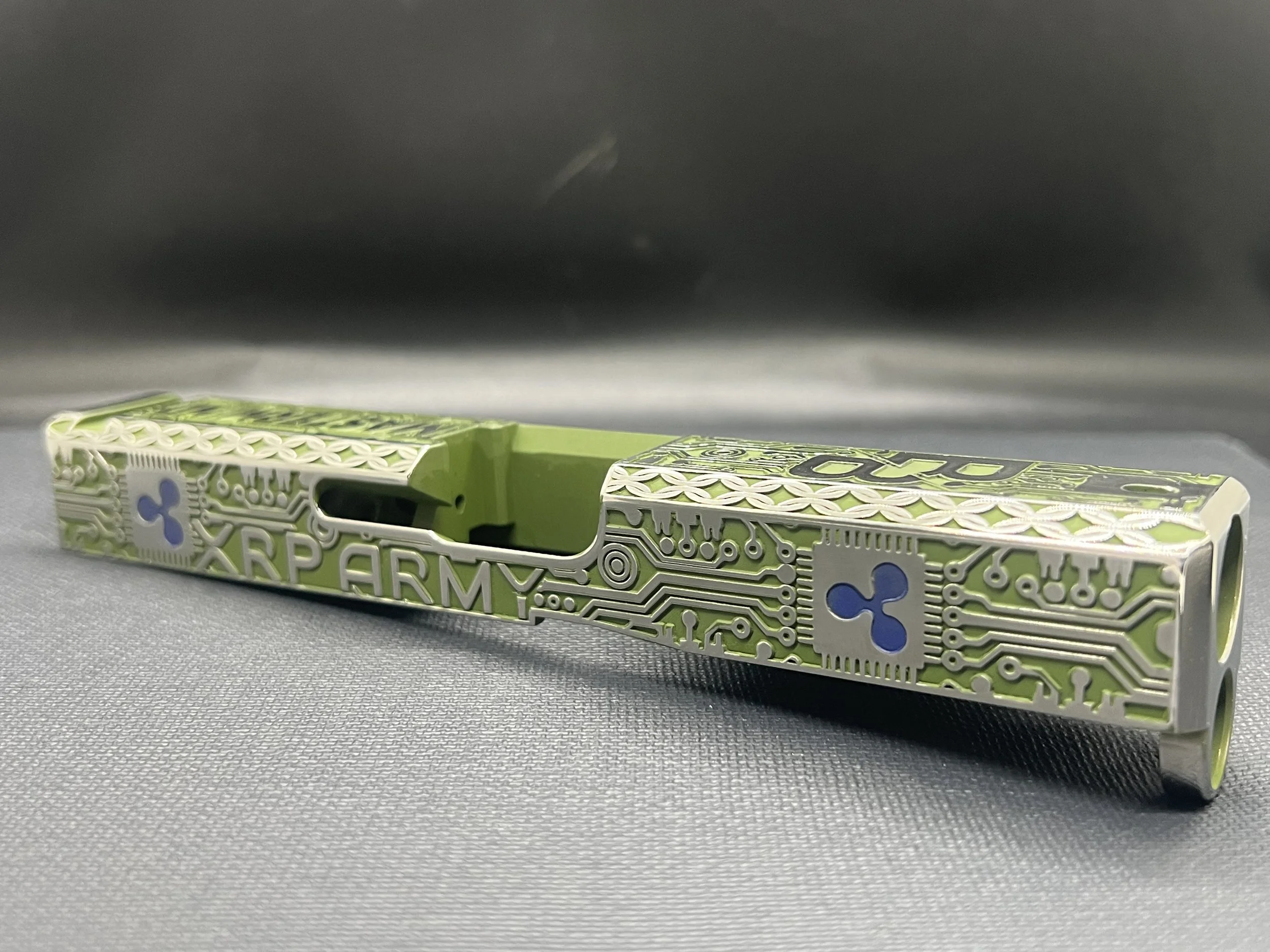 Custom Glock® 17 Gen 5, Ripple XRP themed, slide with circuit-style engraving and green Cerakote finish, designed, laser engraved, and custom finished for a client project.