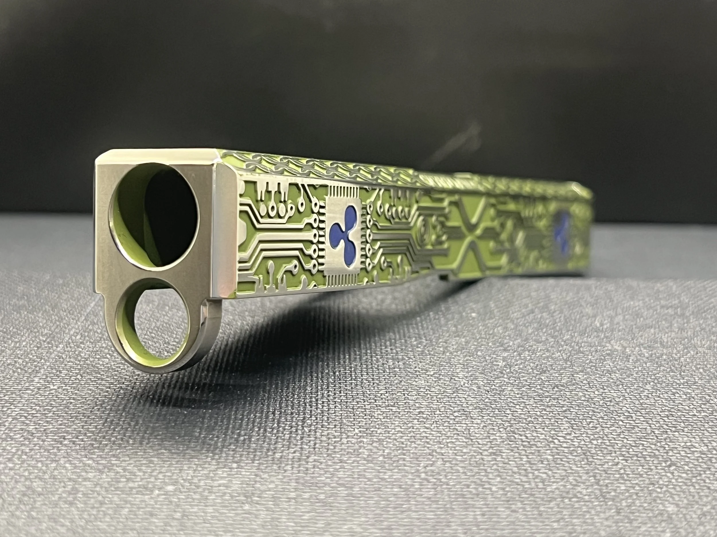 Custom Glock® 17 Gen 5, Ripple XRP themed, slide with circuit-style engraving and green Cerakote finish, designed, laser engraved, and custom finished for a client project.