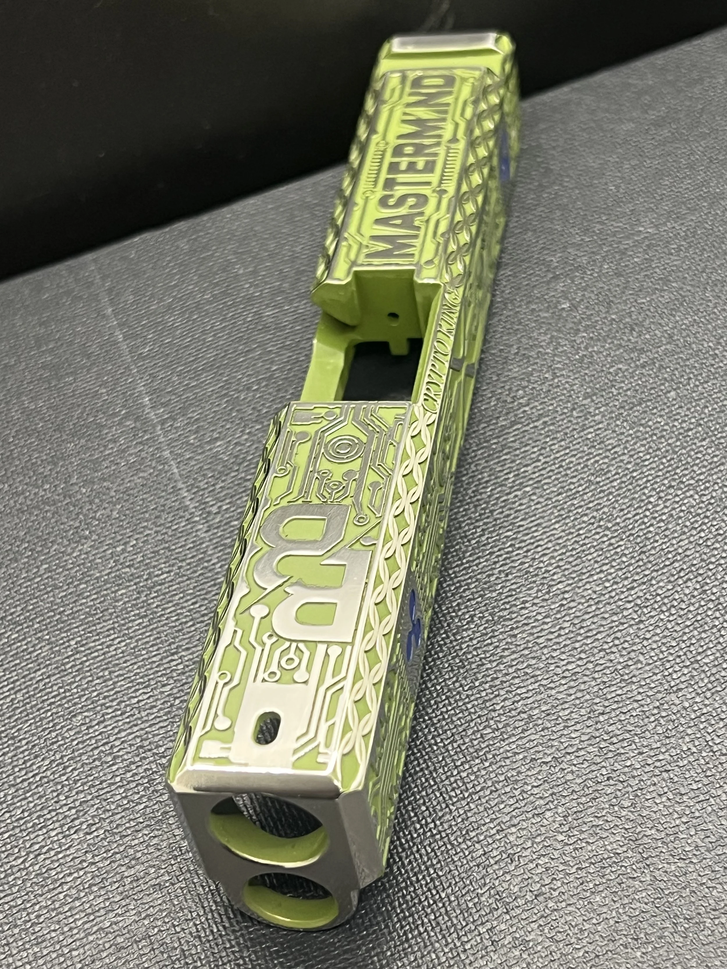 Custom Glock® 17 Gen 5, Ripple XRP themed, slide with circuit-style engraving and green Cerakote finish, designed, laser engraved, and custom finished for a client project.