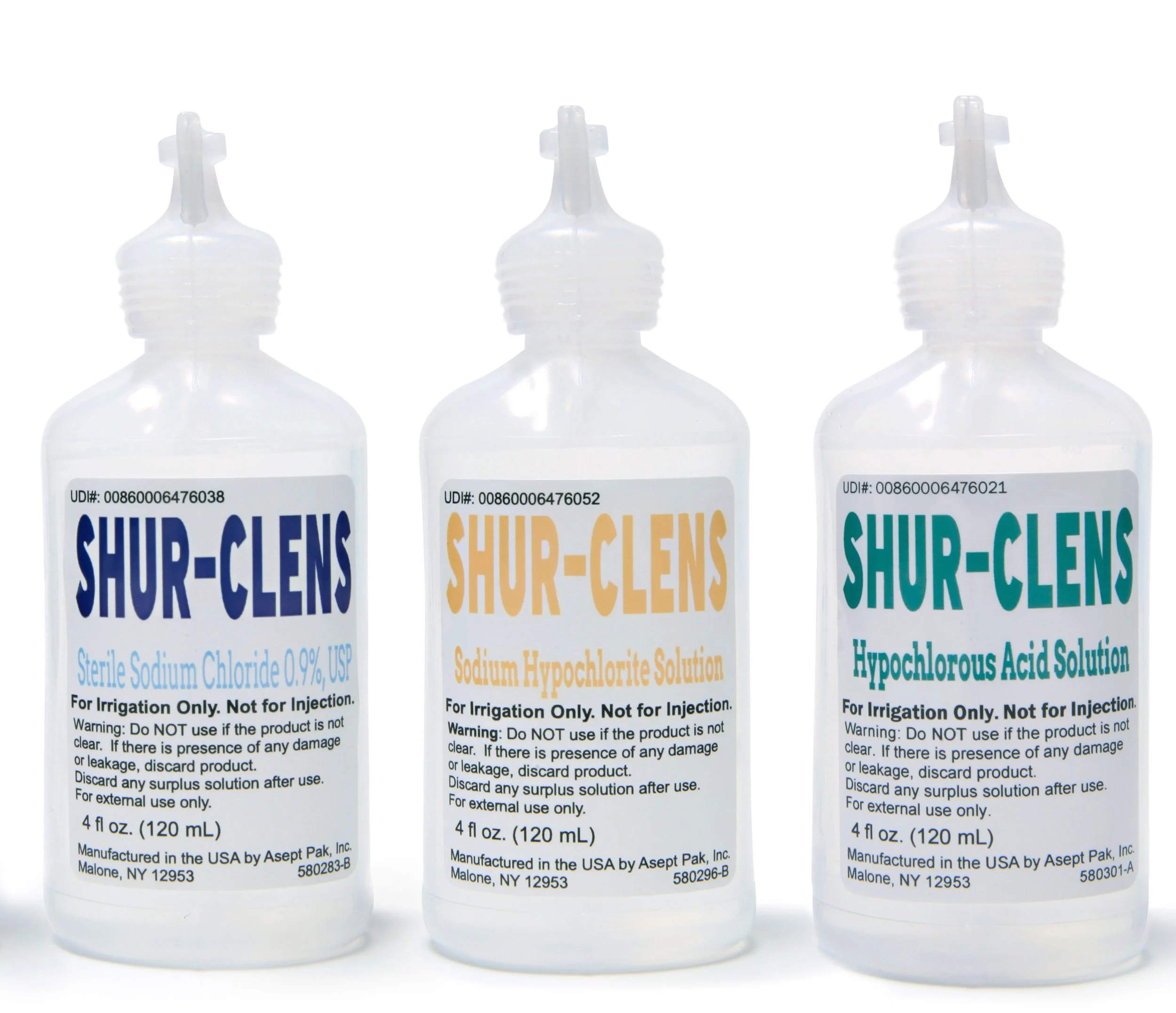 Three bottles of SHUR-CLENS solutions, each labeled for irrigation use, with different chemicals and labels, standing side by side.