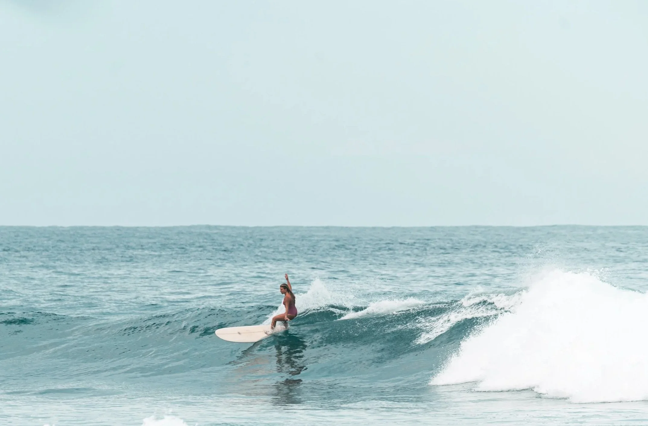 Surfer riding ocean waves during a daytime coastal adventure experience