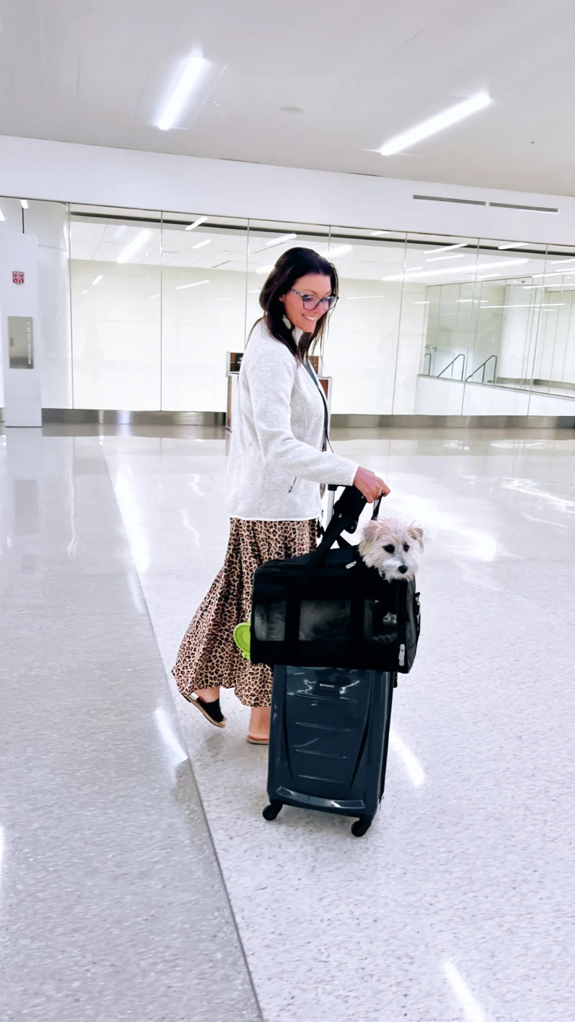 Founder of Latitude Lens traveling through an airport with her dog, capturing a lifestyle rooted in travel and movement