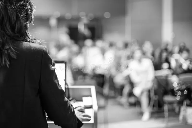 public-speaker-giving-talk-business-event-female-corporate-conference-unrecognizable-people-audience-hall-137393688.jpg.webp