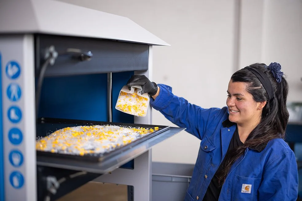 Scooping up plastic shreds onto the sheetpress mould.