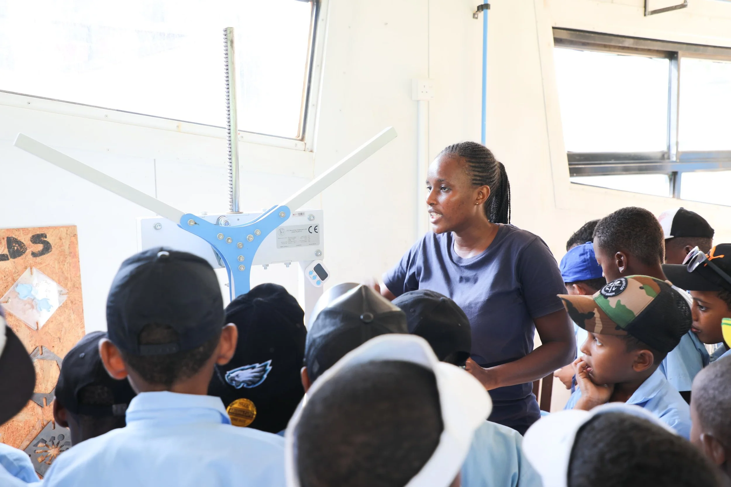 an audience of kids listening to an educational workshop about plastic recycling using the mad plastic arbor press injection machine