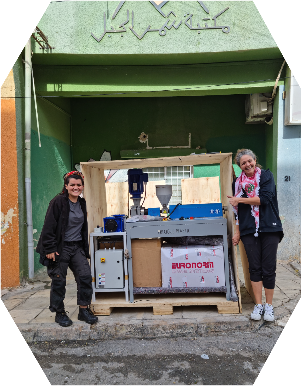 Caro posing with the Extruder machine shipped to start a women run recycling center in Jordan.
