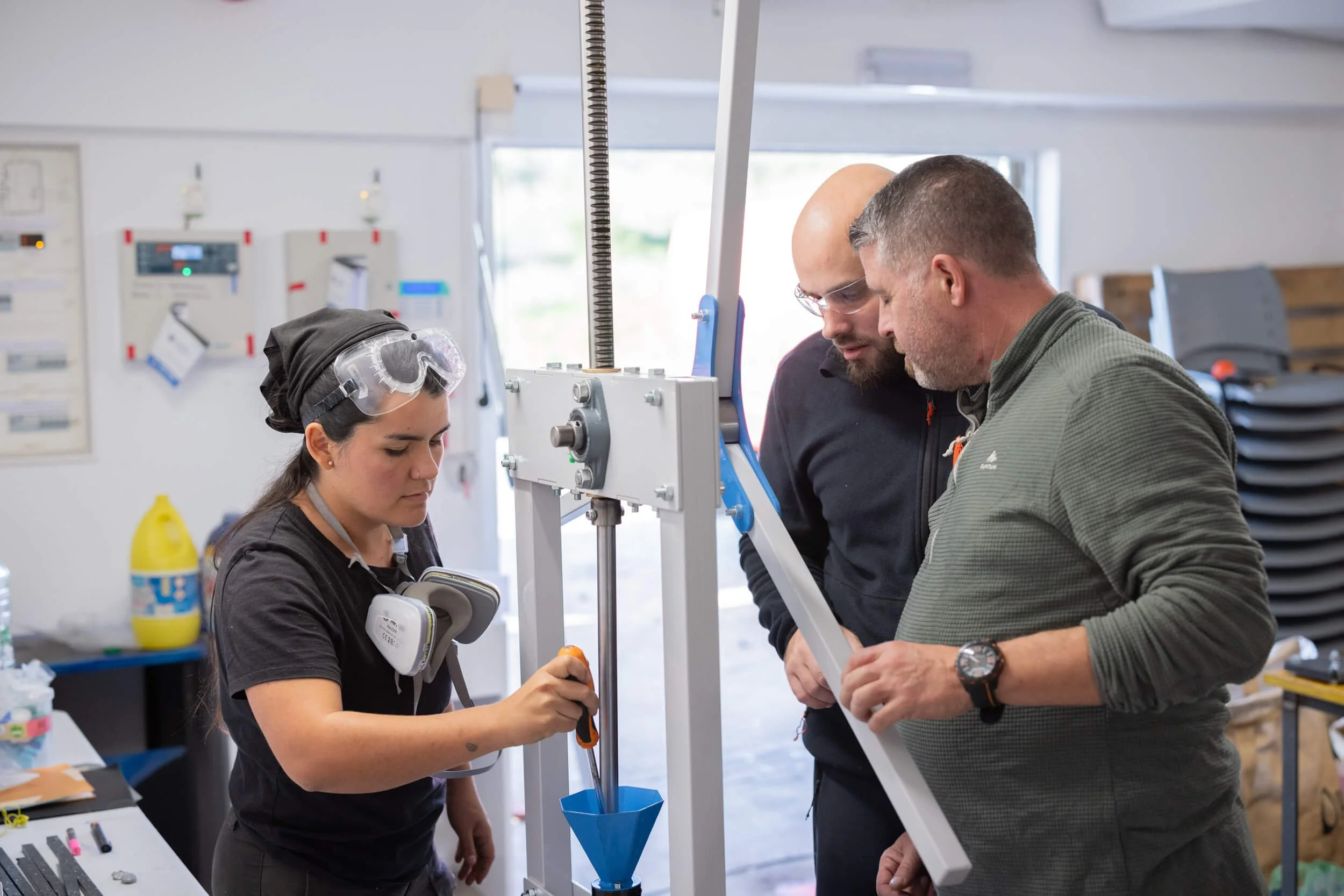 people gathered around the injection machine in a fab lab in sintra portugal