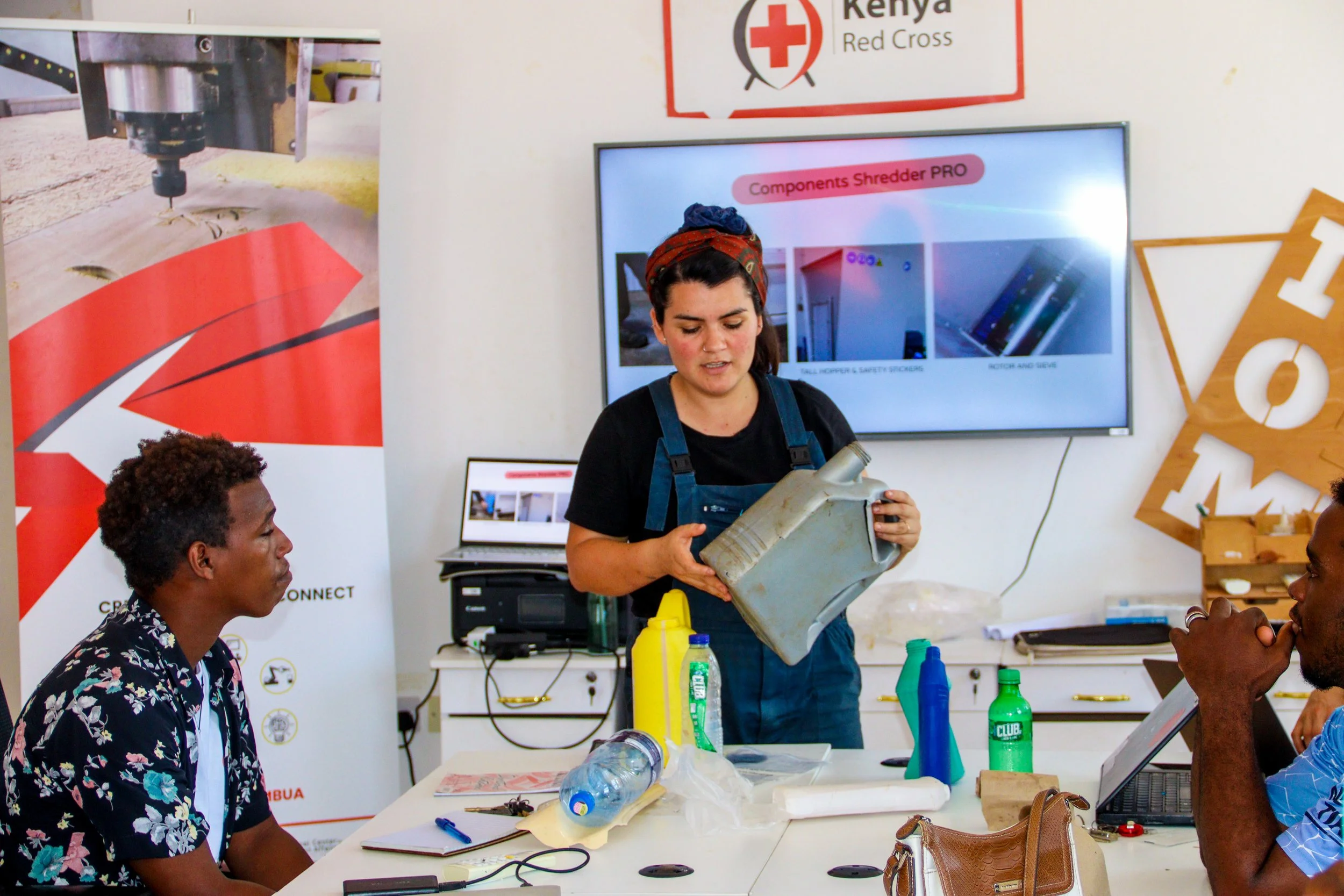 Caro is demonstrating the properties of different types of plastic waste during a training session in Gabon.