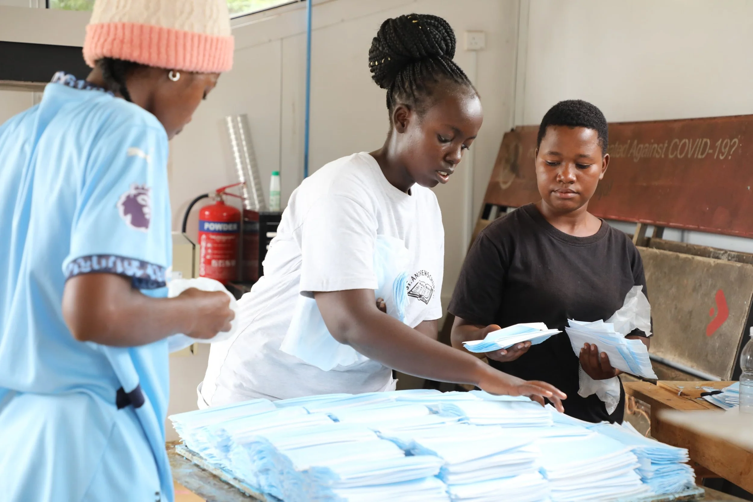 Two newly trained plastic recyclers are testing a Sheetpress machine, in a fablab in Kenya. 