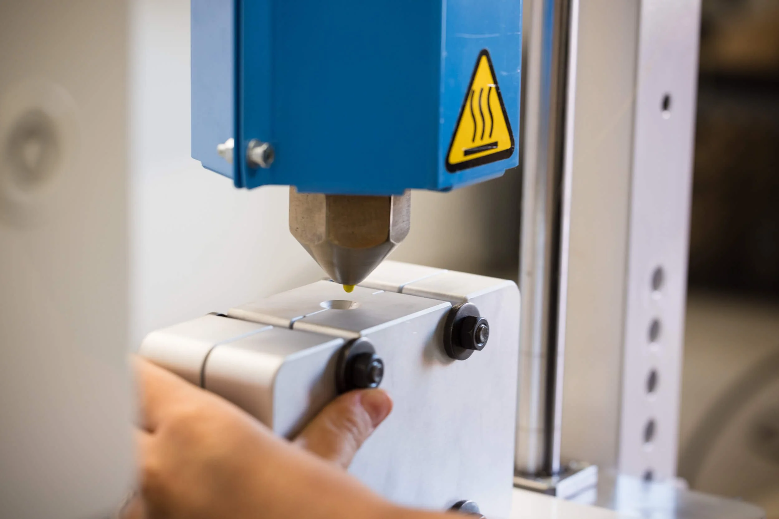 Placing a mould under the nozzle of the injection machine.