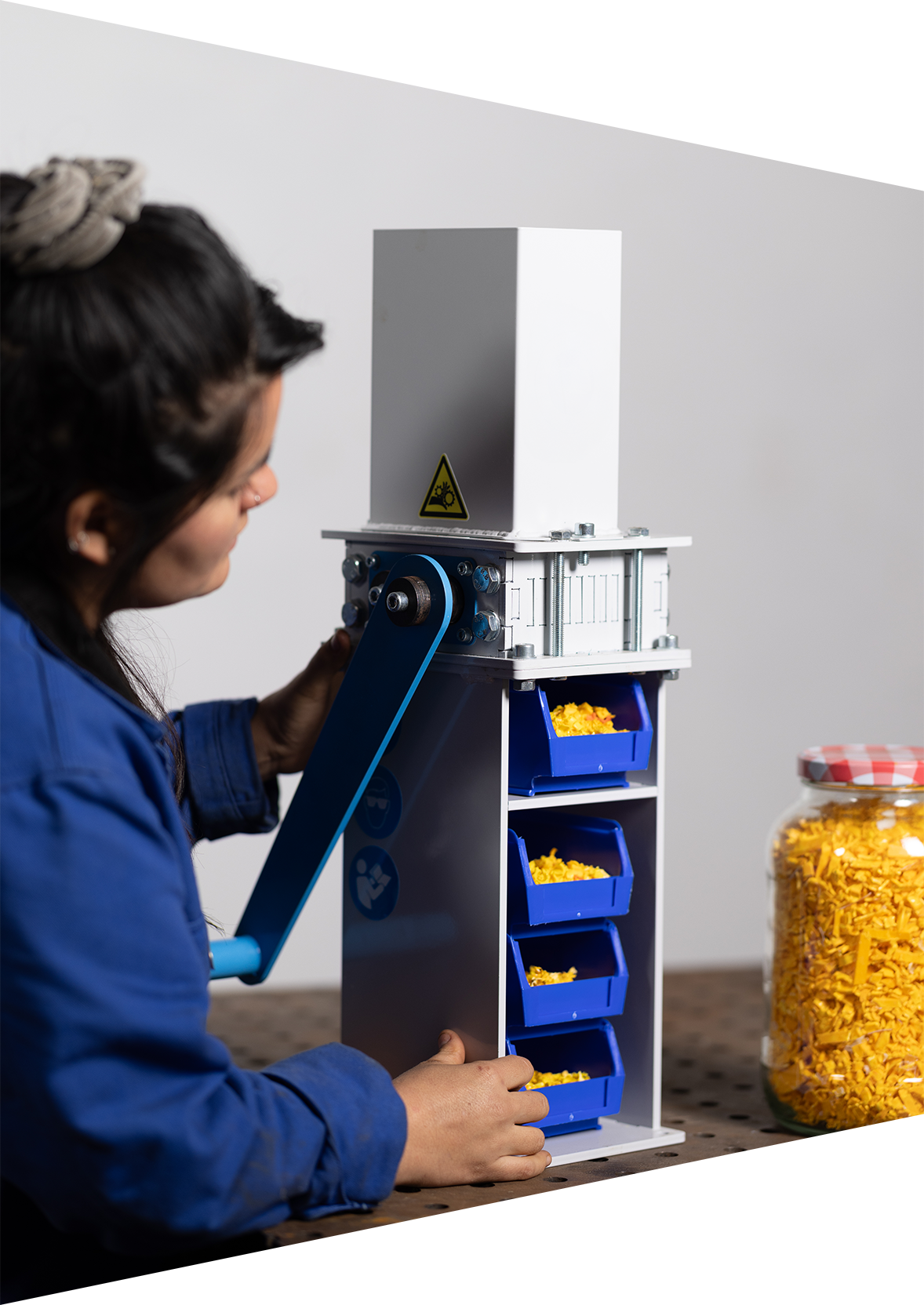 Close-up of Caro showing the Mini Shredder, with containers filled with plastic shreds.