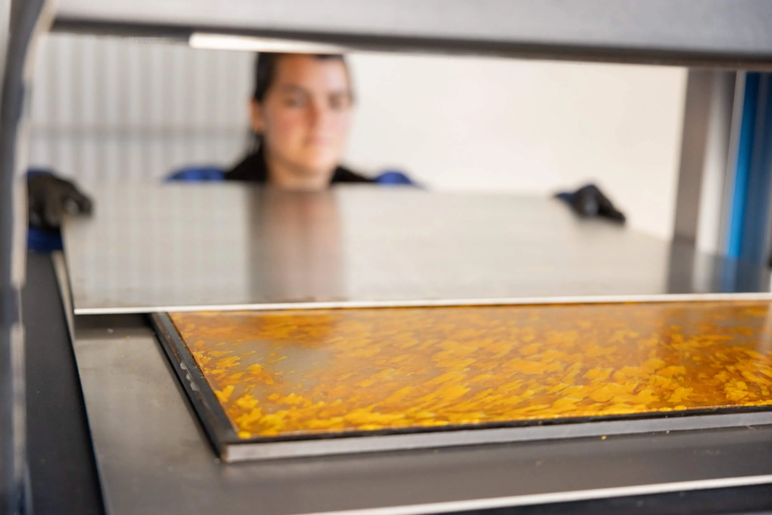 Getting a recycled plastic sheet out of the sheetpress.