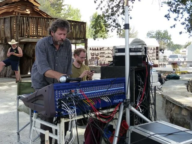 Paul Knight working with audio equipment during the Parkfield Bluegrass Festival