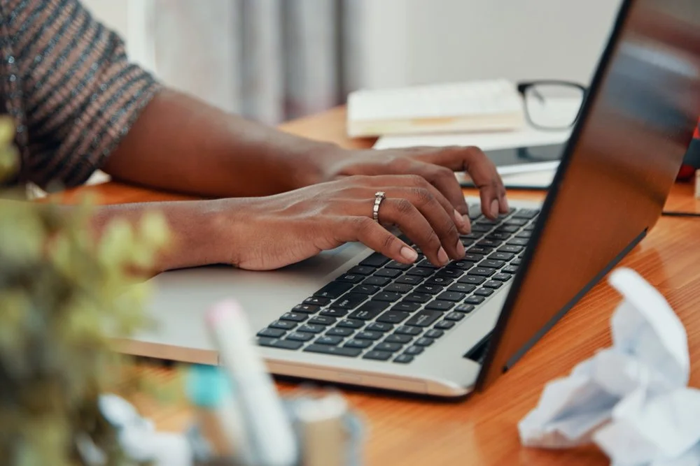 A person typing on a keyboard.
