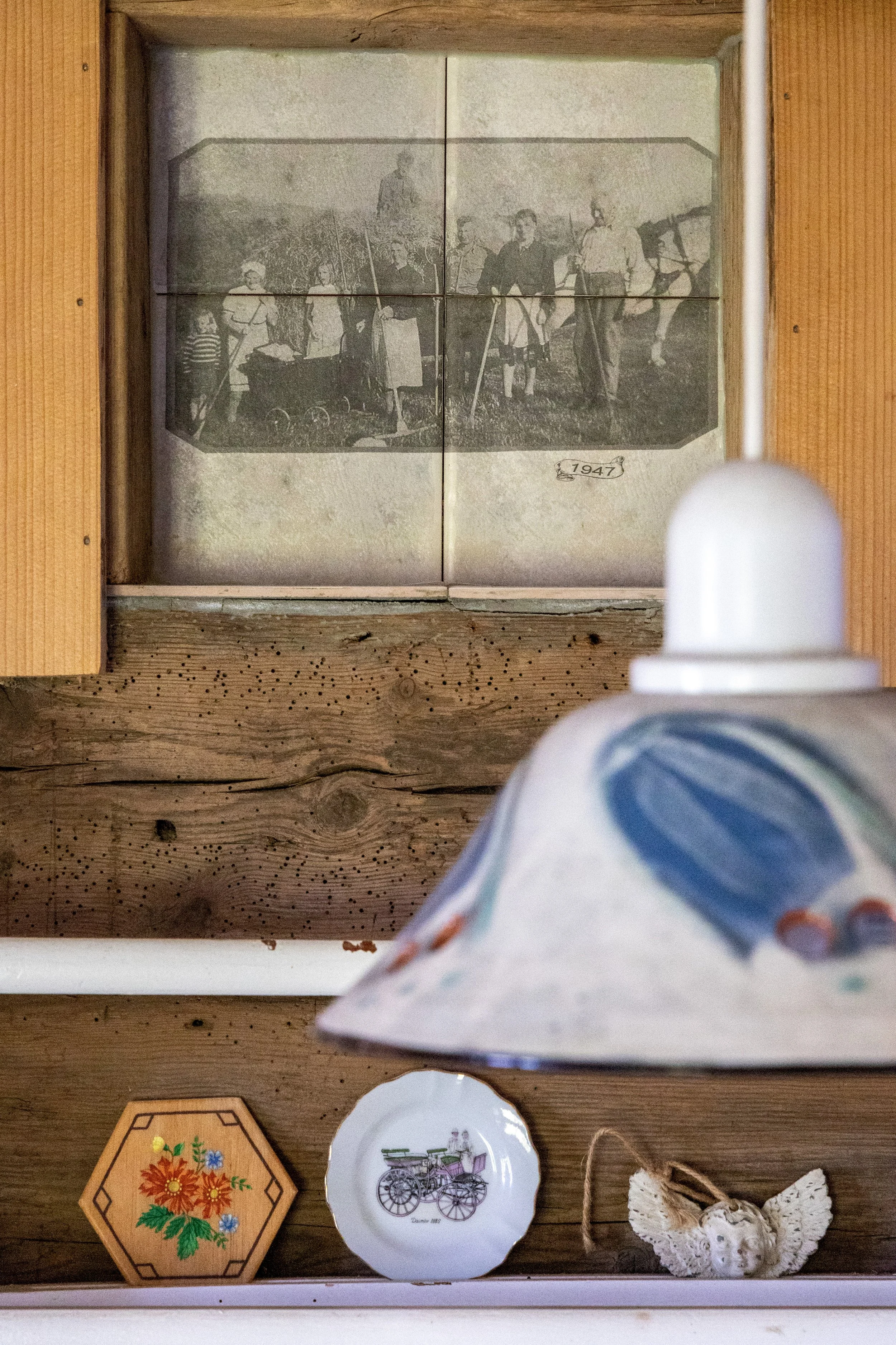 Historic photographs are found printed on tiles, a reminder of the long history of the house