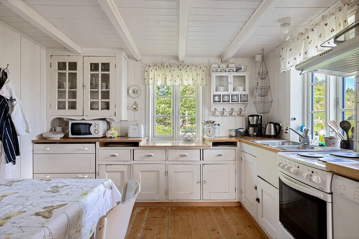 The kitchen includes a dishwasher, a stove, a microwave, and a fridge. A separate freezer is located on the second floor