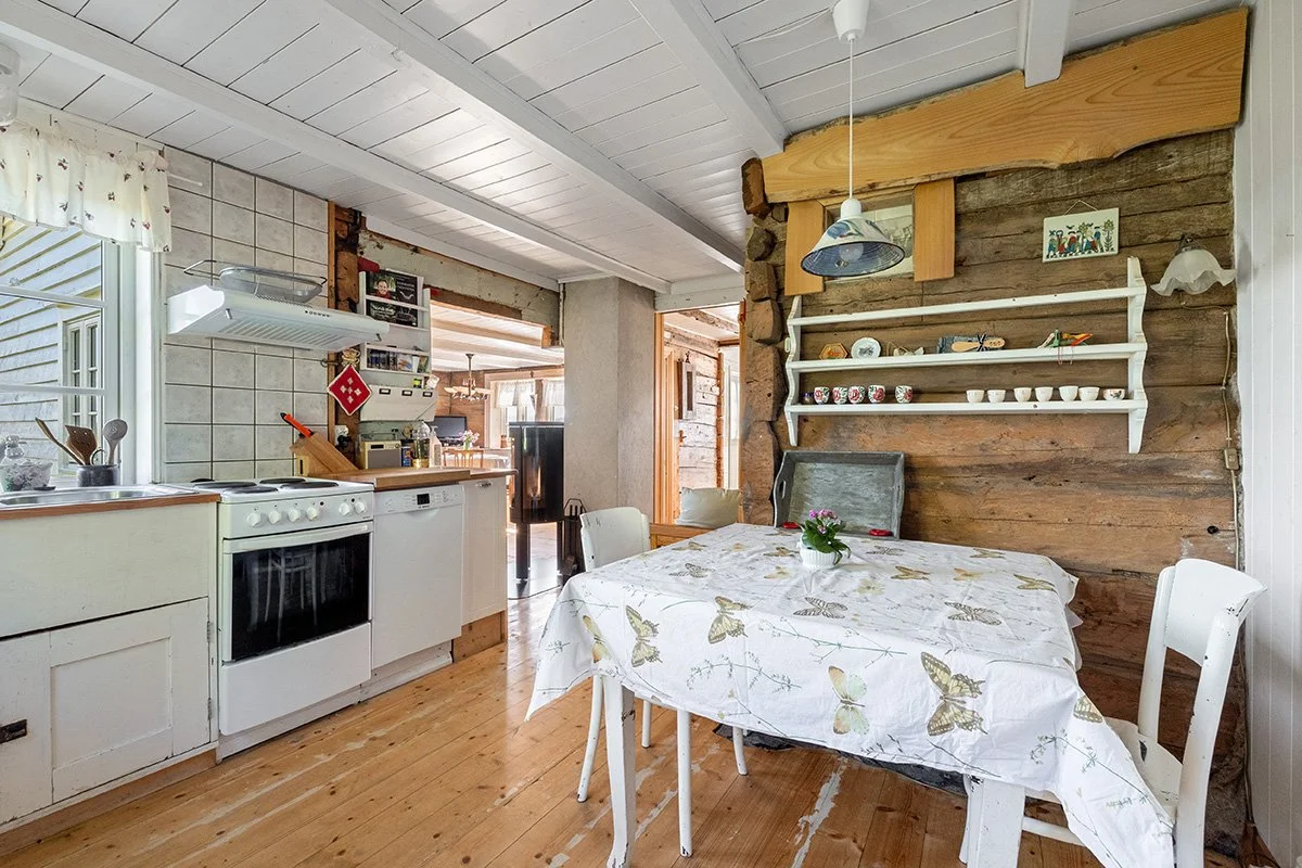 The kitchen has a dining table seating four