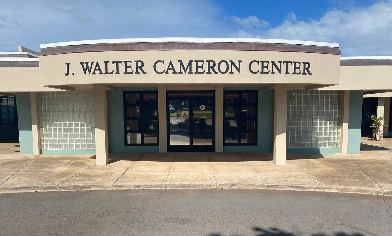 Front view of the J. Walter Cameron Center building with a beige facade and large windows