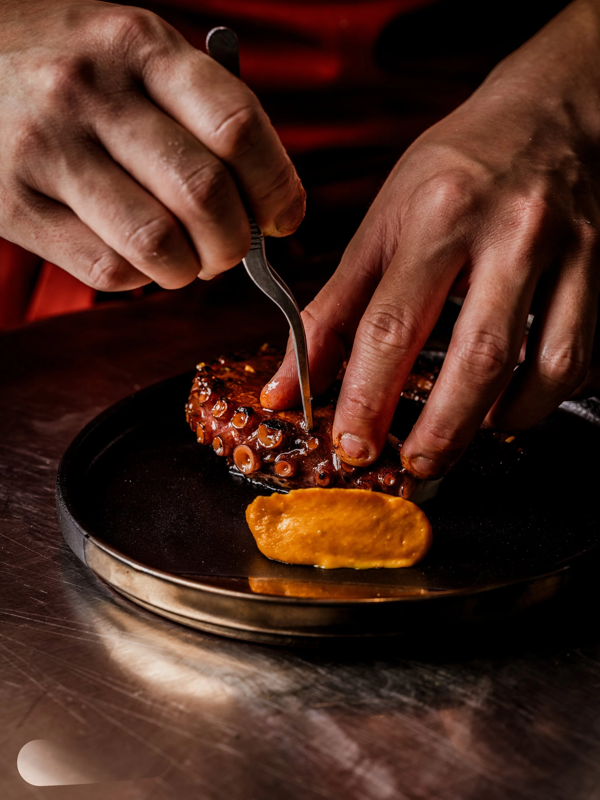 An octopus leg being prepped