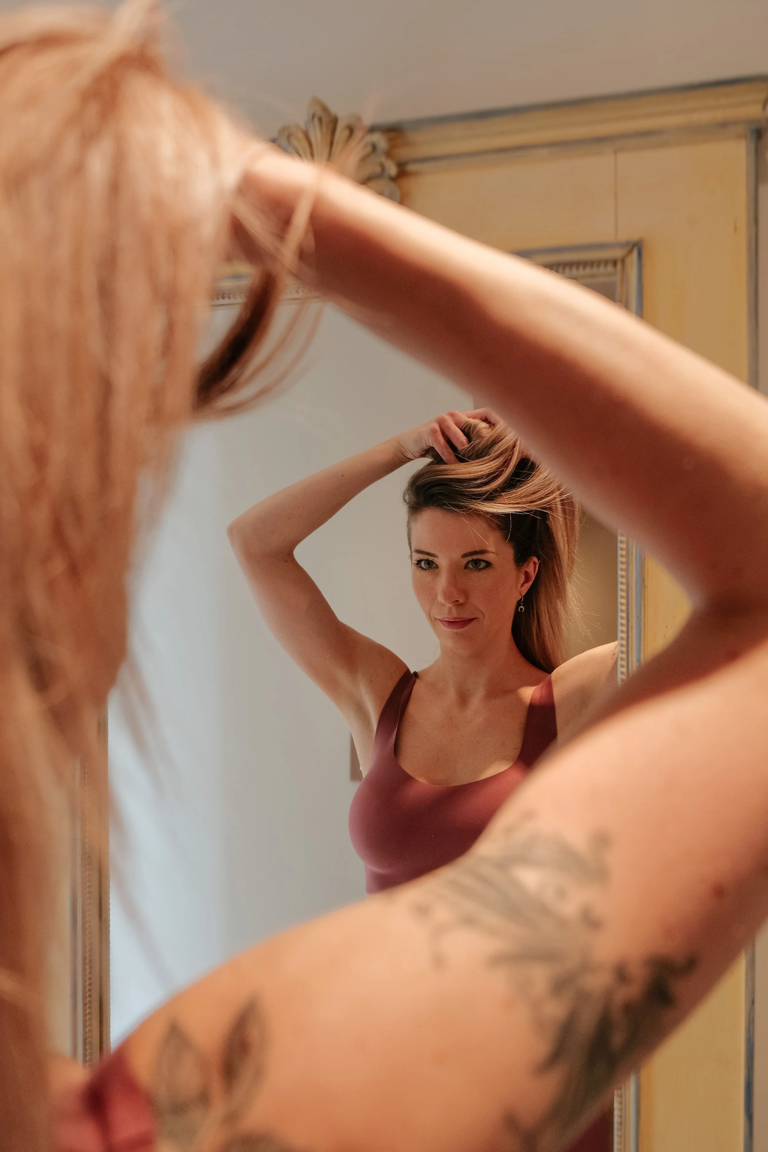 Reportage photo réalisé à Lyon : séance yoga lifestyle en intérieur, moment de préparation devant le miroir et ambiance naturelle.