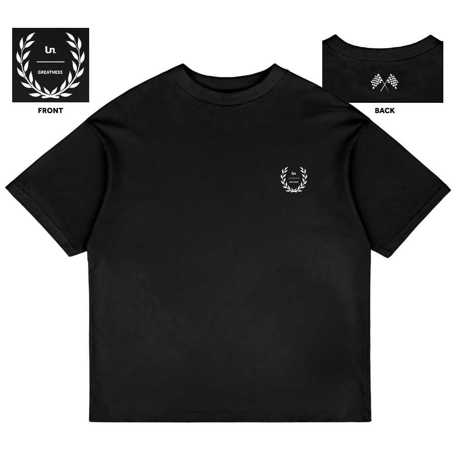 Black T-shirt with a small white laurel wreath logo and text that reads 'Un. Greatness' on the chest, and a small black and white checkered flag design on the back neckline.