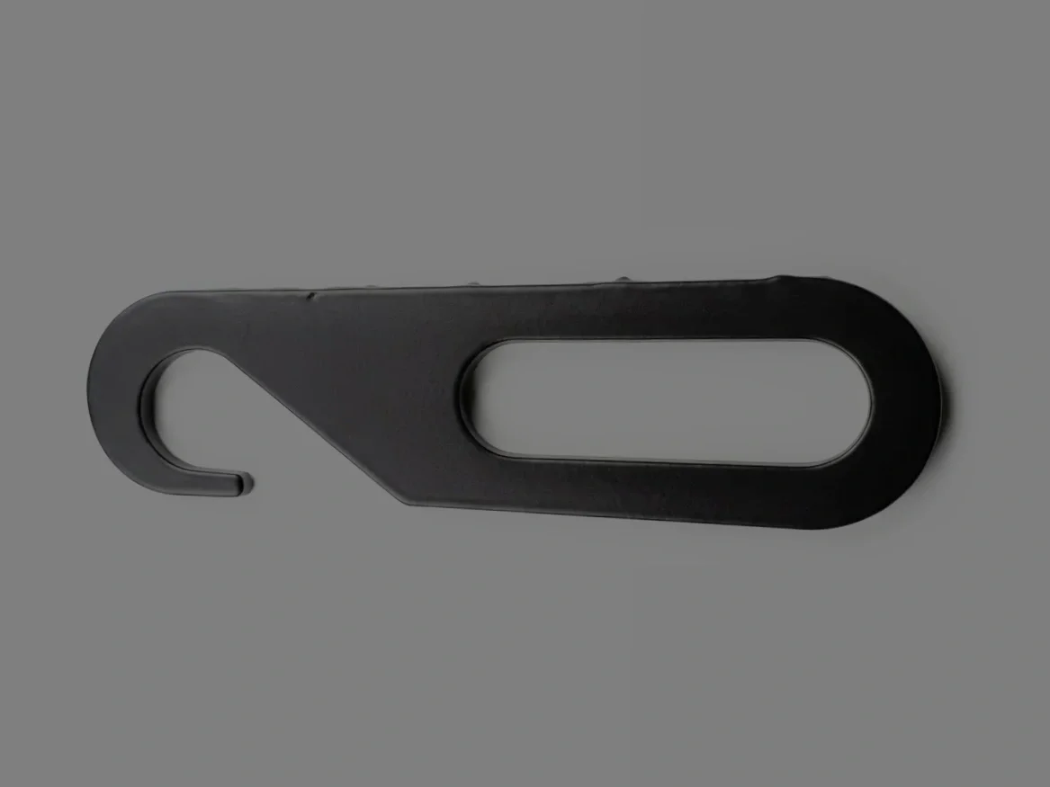 A black plastic hanger with an oval hole in the center, designed for hanging clothing or items.
