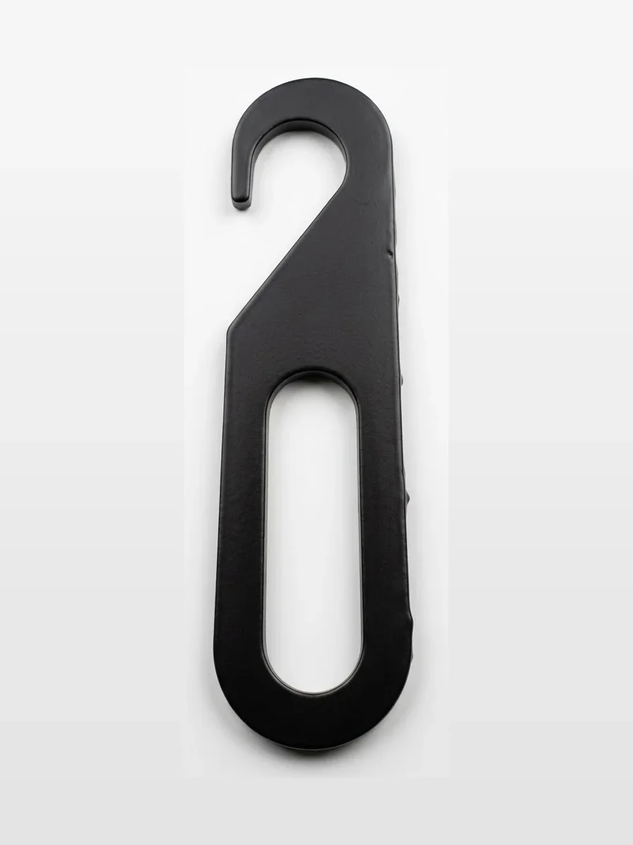 A black plastic hanger with an oval hole in the center, designed for hanging clothing or items.