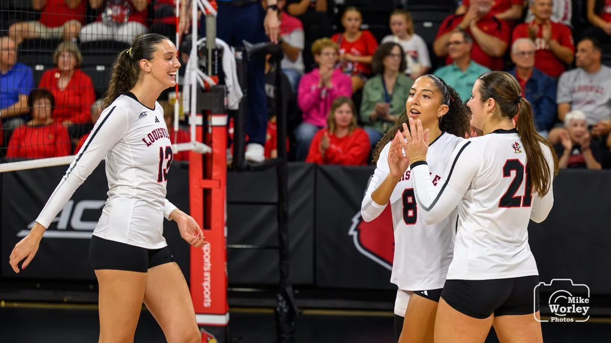 Cara Cresse (13), Nayelis Cabello (8) and Payton Petersen (21) celebrate a point