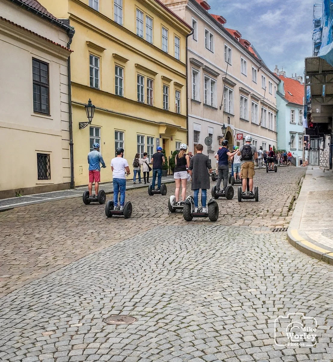 Segways are a popular form of transport around Prague. Note the cobblestone streets