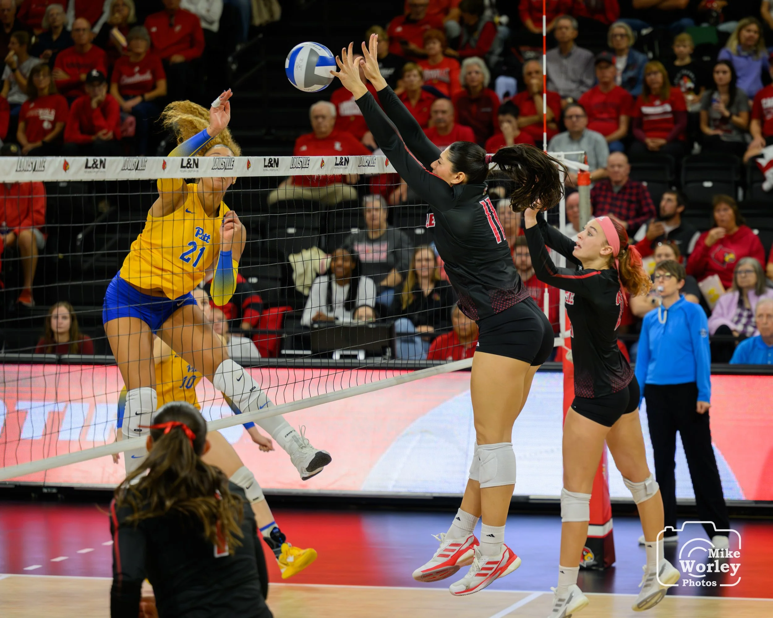 Hannah Sherman with a solo block backed by Kalyssa Blackshear