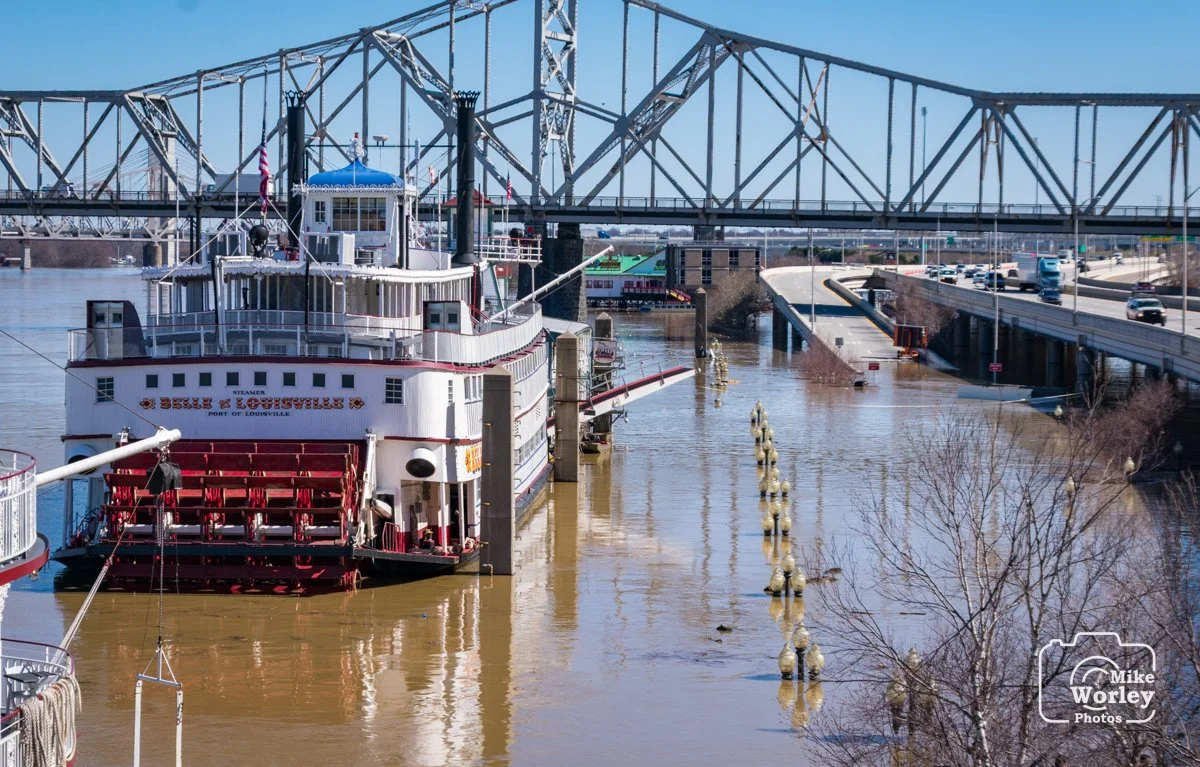 The Belle of Louisville rides high at anchor on the waterfront during the 2018 flood. Note the exit ramp from I-64 in the background. The mostly submerged lamp posts along the river walk are 12 feet tall.