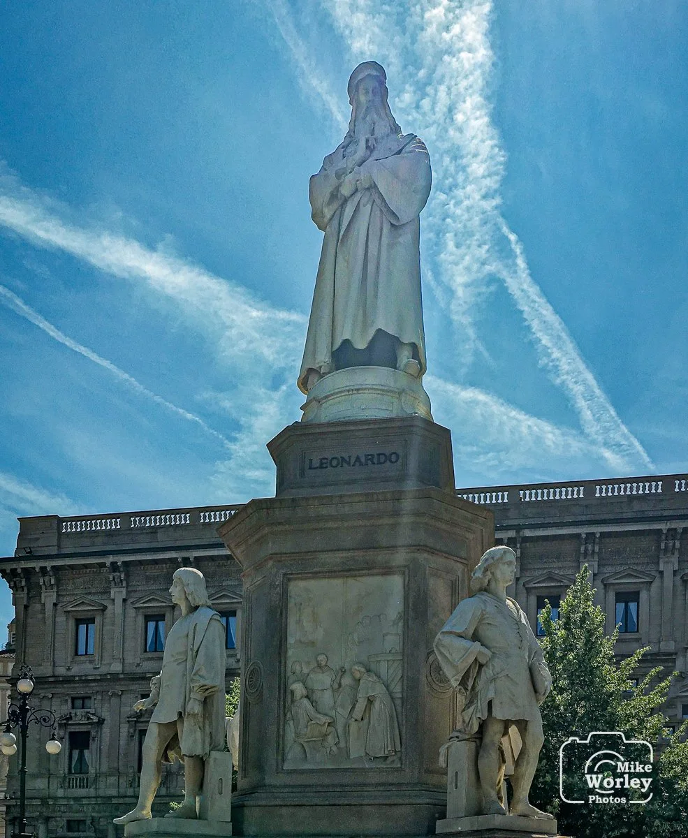 Statue of Leonardo da Vinci surrounded by four followers. Leonardo lived in Milan from 1482 to 1499 and again from 1508 to 1513. His famous The Last Supper was painted in Milan.