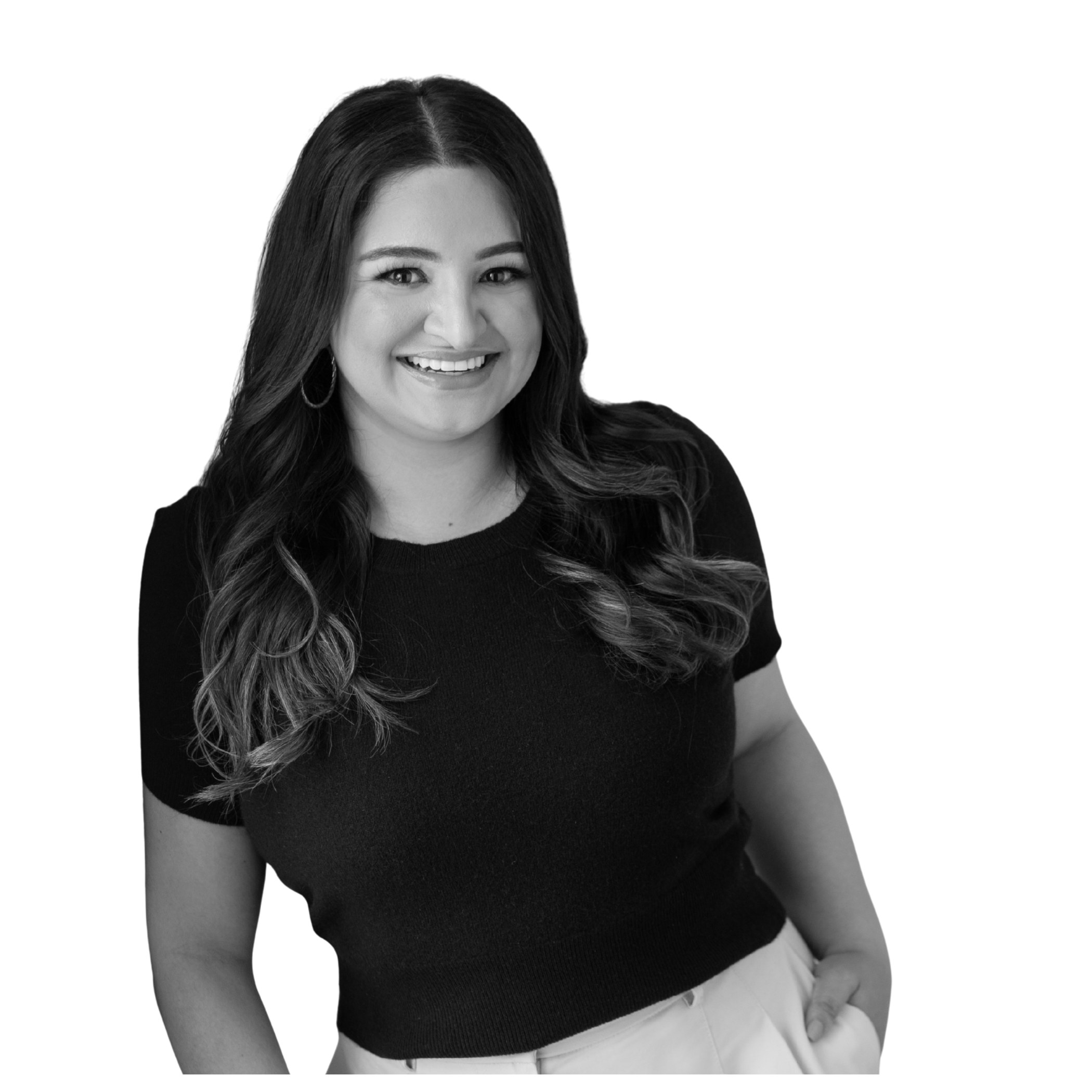 Itzel Moncada. A smiling woman with long wavy hair, wearing a black top and earrings, posing against a black background.