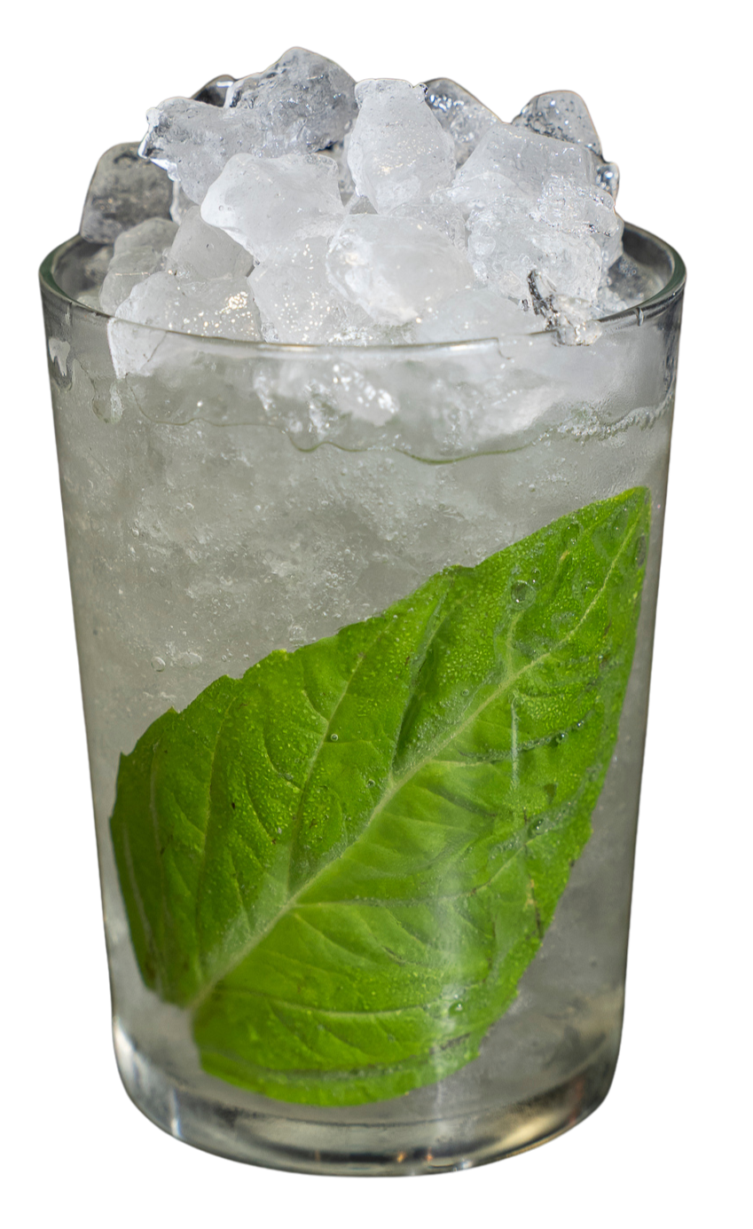 Cocktail with pebble ice and green mint leaf in glass