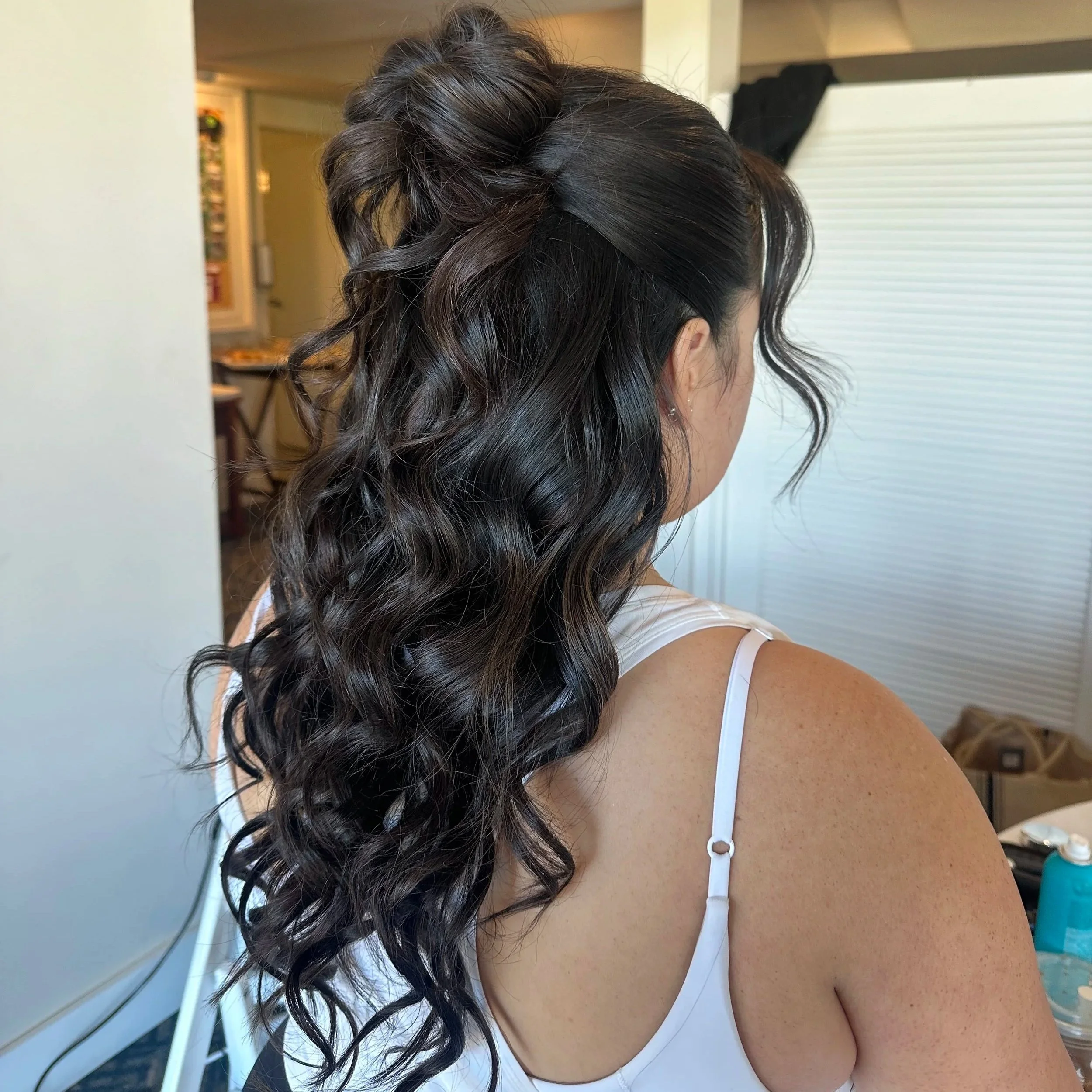 Bride with long brunette curls and half-up hairstyle