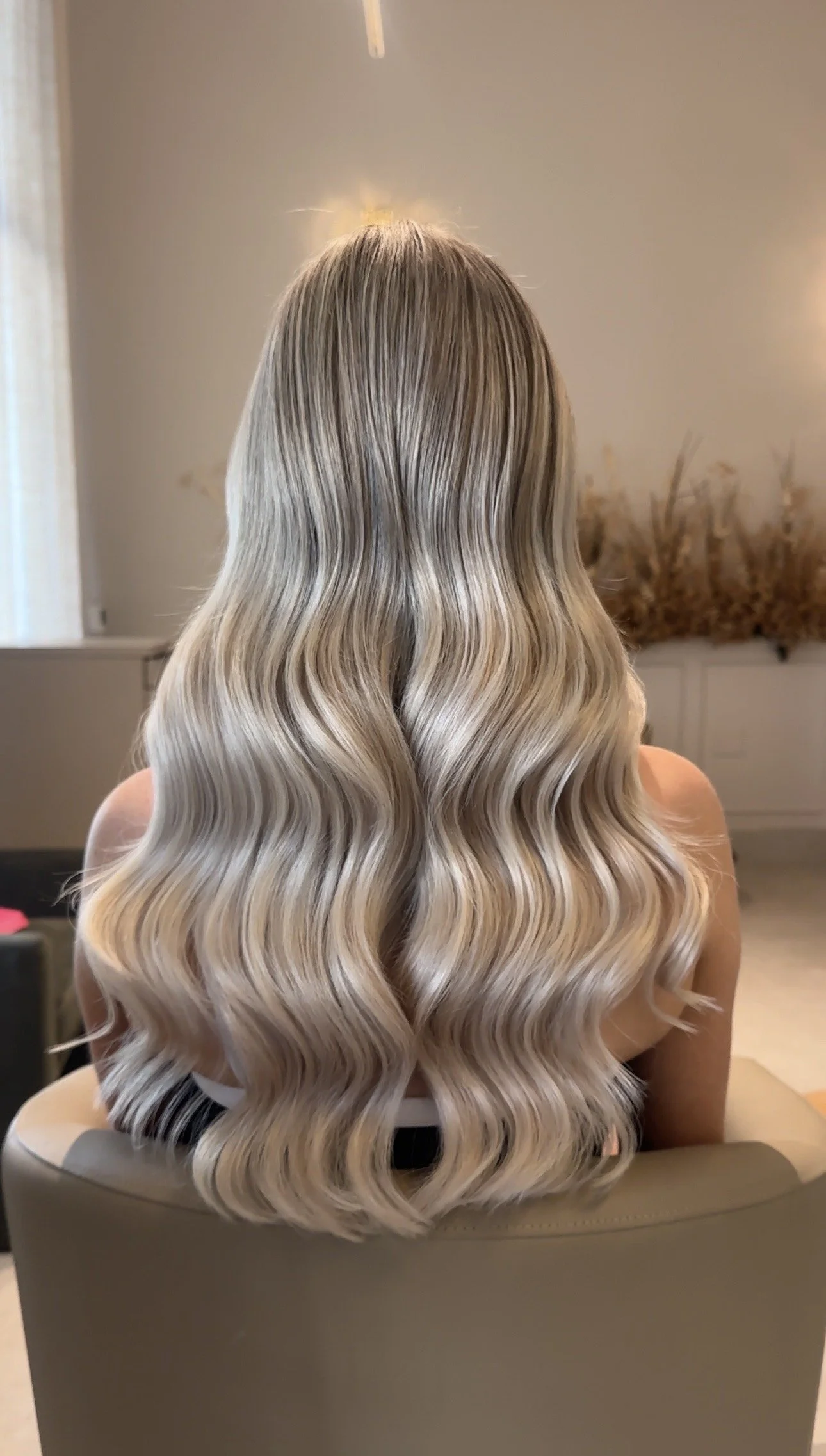 Bride with long blonde hair styled in polished soft waves